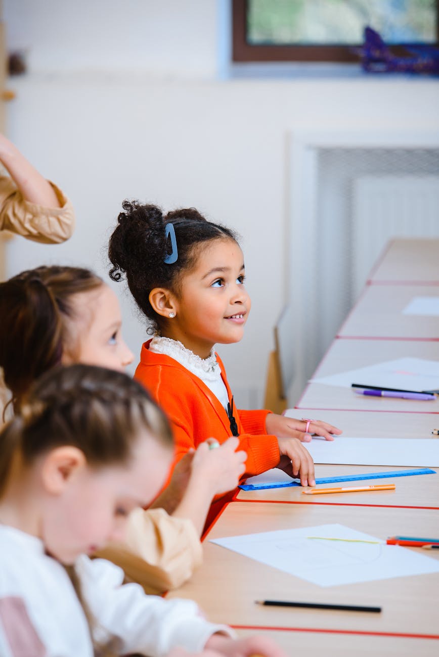 side view of children sitting on table