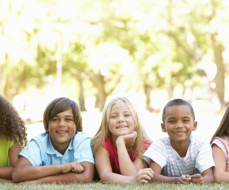 A group of children lying in a park