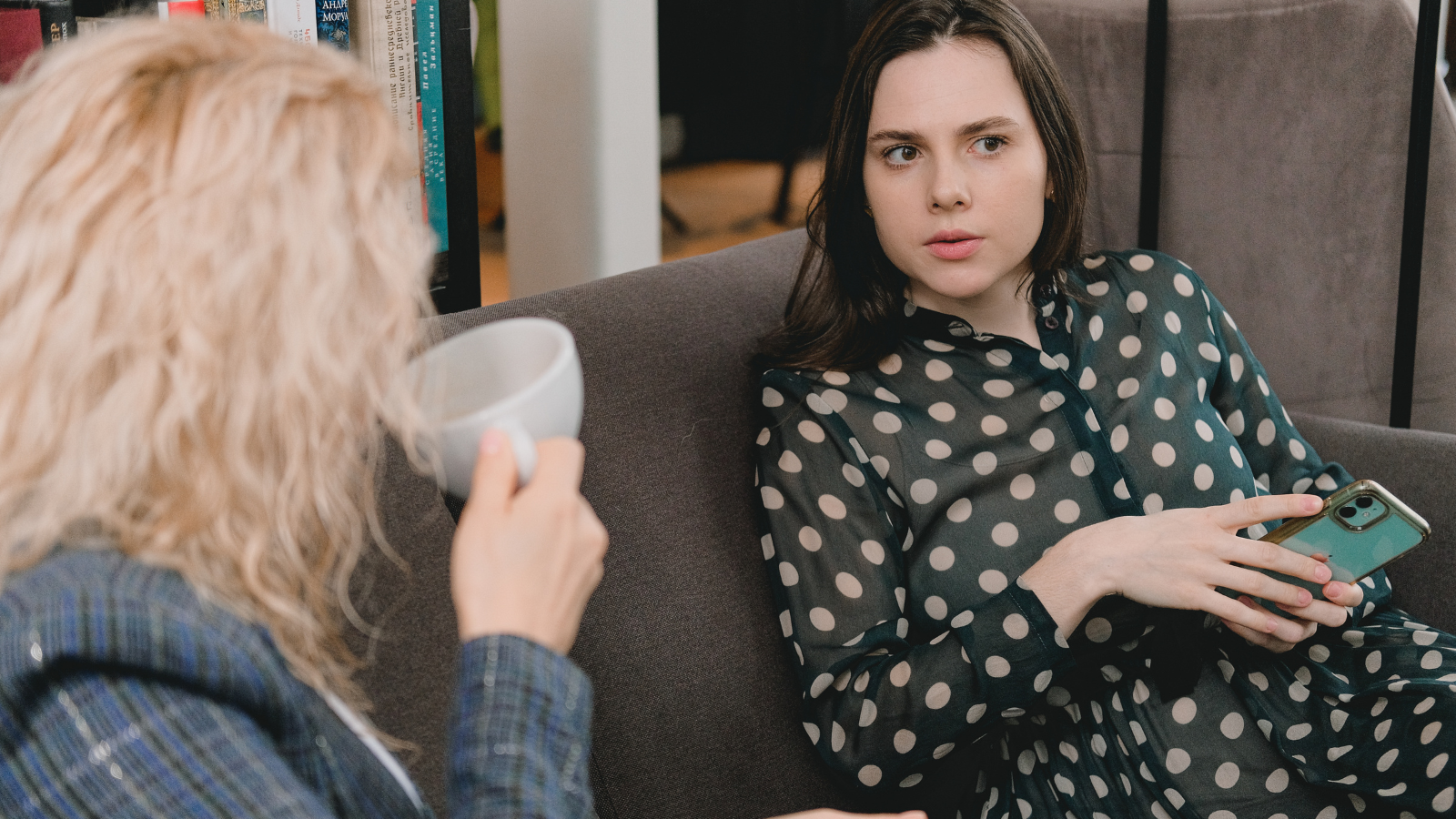 Two women talking on a couch