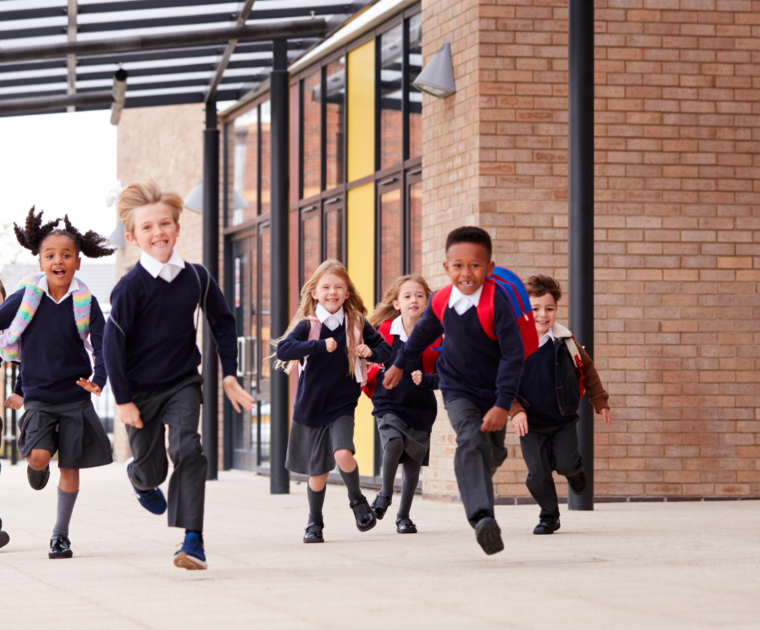 Children running outside at a school
