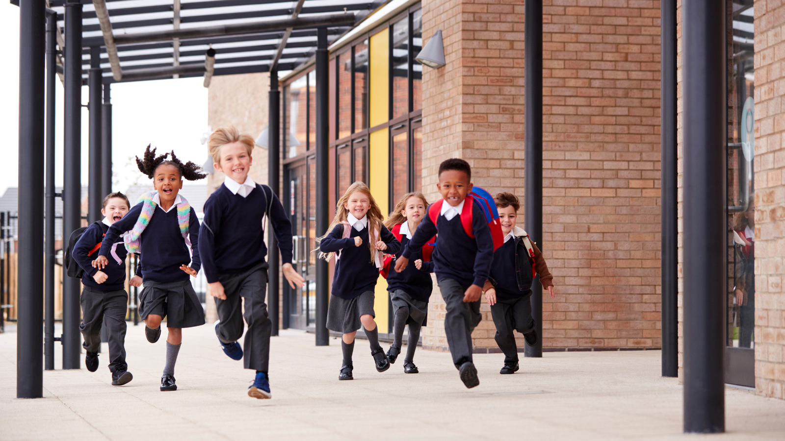 Children running outside at a school